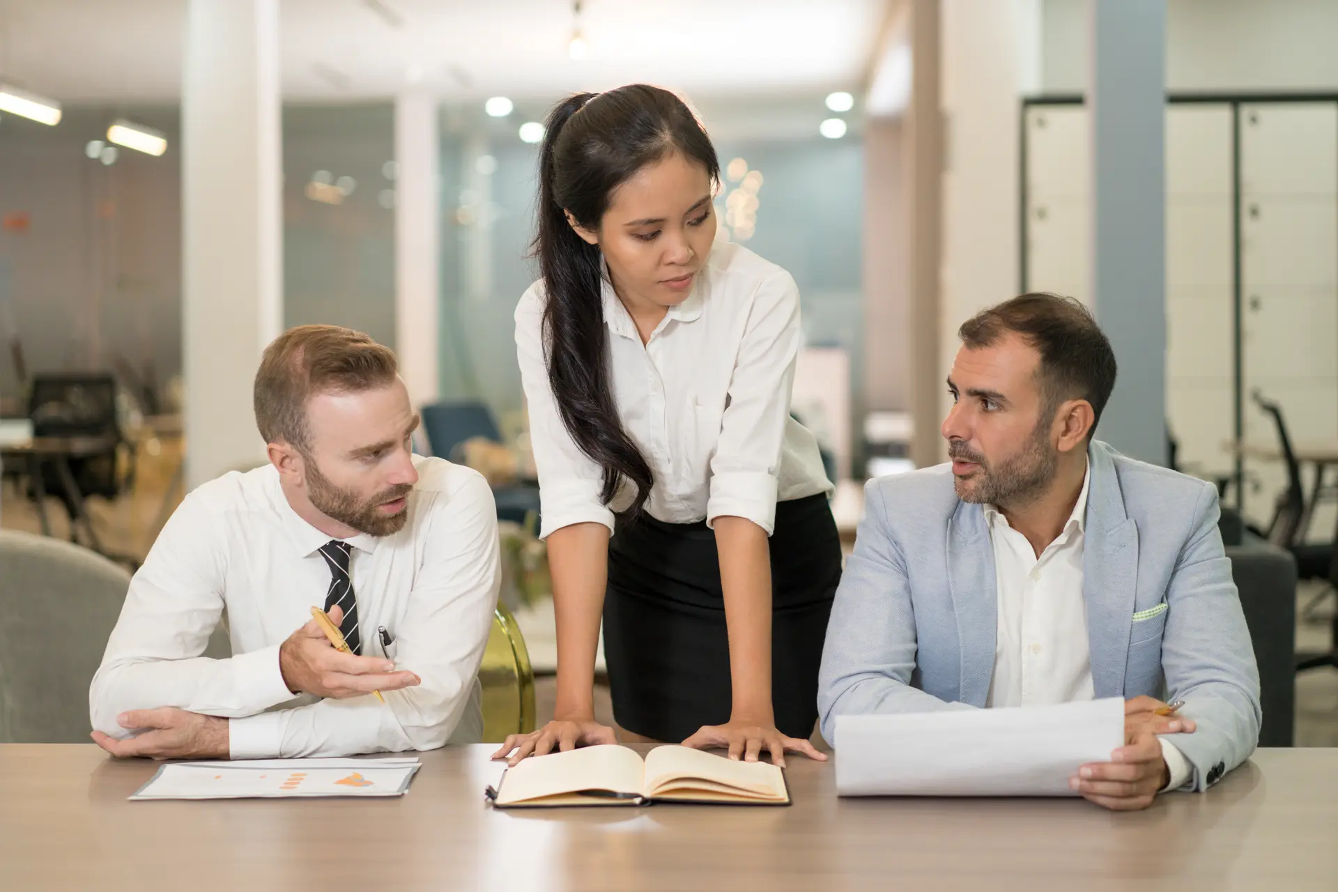 Corporate lawyers reviewing compliance documents in an office setting
